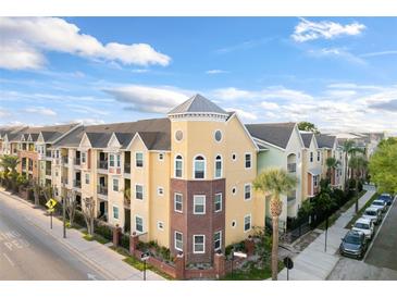 Stunning exterior view of a colorful condominium complex with unique architectural details and landscaping at 1910 E Palm Ave # 10301, Tampa, FL 33605