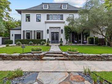 Stunning two-story home featuring a manicured lawn, stone accents, and an inviting double-door entrance at 2603 W Parkland Blvd, Tampa, FL 33609