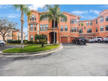 Beautiful Mediterranean style condo complex with attached garages, manicured landscaping and ample parking spaces at 2747 Via Capri # 1122, Clearwater, FL 33764