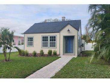 Charming bungalow with a newly landscaped front yard and a brick walkway to the front door at 4541 2Nd N Ave, St Petersburg, FL 33713