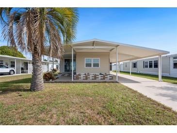 Charming single-story home with carport and mature palm tree in a sunny, well-maintained community at 5238 Vera St, Zephyrhills, FL 33542