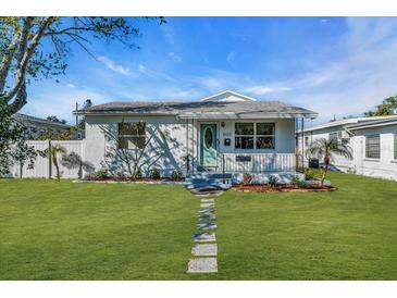 Charming single story home featuring a well-manicured lawn, stone pathway, and quaint front porch at 4053 11Th N Ave, St Petersburg, FL 33713