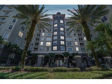 Elegant condominium exterior showcasing architectural details and lush landscaping and two large palm trees at 700 S Harbour Island Blvd # 735, Tampa, FL 33602