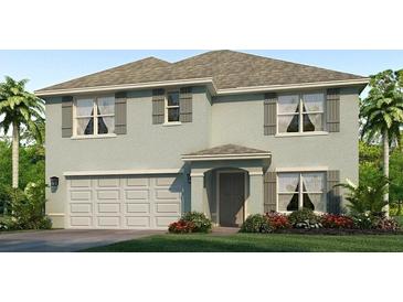 Inviting two-story home featuring a two-car garage, gray shutters, and well-manicured landscaping at 10865 Gentle Current Way, Parrish, FL 34219