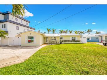 Charming single Gathering home with a well manicured lawn and metal roof at 7984 1St S Ave, St Petersburg, FL 33707