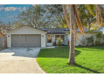 Charming single-story home featuring a two-car garage and a well-maintained lawn at 2195 Glen Dr, Safety Harbor, FL 34695