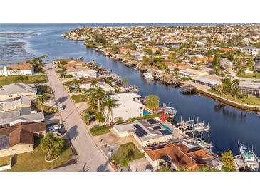 Waterfront property showcasing a private pool and boat dock with gulf access in a canal community at 3939 Rudder Way, New Port Richey, FL 34652