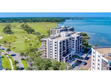 Stunning aerial view of condo building overlooking the golf course, and tranquil bay waters at 6 Belleview Blvd # 203, Belleair, FL 33756