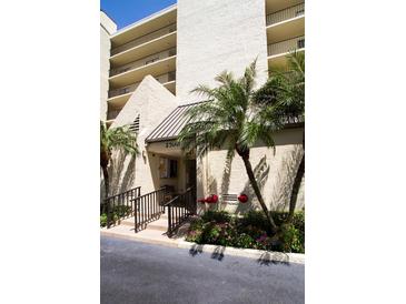 Attractive building entrance featuring nice landscaping and ample space to welcome residents and guests at 2700 Cove Cay Dr # 4-B, Clearwater, FL 33760