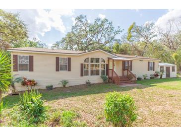 Charming single-story home featuring a covered front porch, neutral siding, and well-maintained landscaping at 36246 Peak St, Zephyrhills, FL 33541