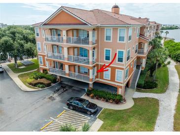 Beautiful condo building featuring Mediterranean architecture, balconies, a parking area and waterfront access at 5000 Culbreath Key Way # 9-102, Tampa, FL 33611