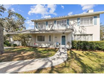 Charming two-story home with a well-manicured lawn, inviting entrance, and light blue shutters at 11124 Corlett Rd, Riverview, FL 33578