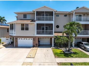 Beautiful three-story exterior featuring multiple balconies and a two-car garage at 219 126Th Ave, Treasure Island, FL 33706