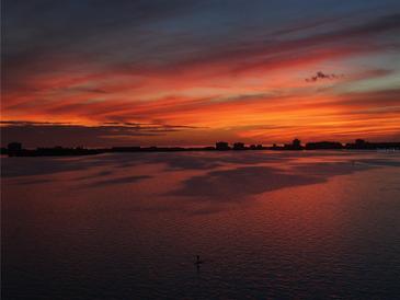 Stunning sunset view over water and city skyline, with vibrant colors and a serene atmosphere at 5980 Shore S Blvd # 1004, Gulfport, FL 33707