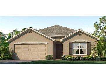 Charming single-story home with a neutral color scheme, landscaped yard, and attached two-car garage at 7804 Wheat Stone Dr, Zephyrhills, FL 33540