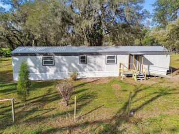 Charming single-story home with mature tree and landscaped front yard at 8408 Bob Wiggs Ave, Lithia, FL 33547