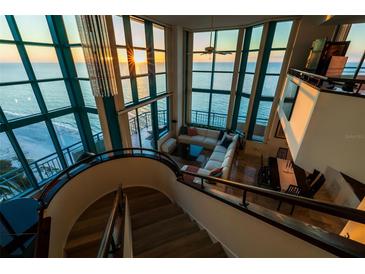 Spacious living room with floor-to-ceiling windows and ocean views from the upper level at 1520 Gulf Blvd # Ph1 1901, Clearwater Beach, FL 33767