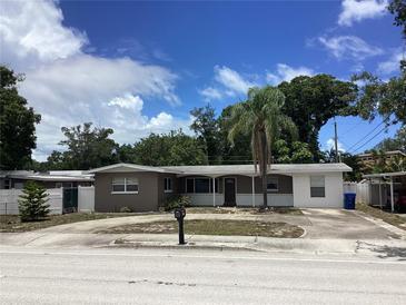 Charming single-story home featuring a well-maintained front yard and mature landscaping at 1811 Ridge S Rd, Largo, FL 33778