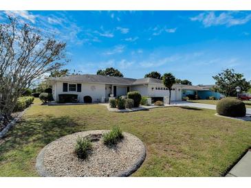 Charming single-story home featuring a well-manicured lawn and beautiful landscaping at 612 Allegheny Dr, Sun City Center, FL 33573