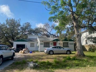 Modest single Gathering home with grass front yard and mature trees at 2804 W Foster Ave, Tampa, FL 33611