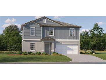 Two-story home showcasing a welcoming facade, attached garage, manicured lawn, and tasteful landscaping at 3635 Forest Path Dr, Plant City, FL 33565