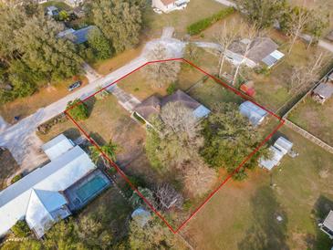 Sprawling property showcasing the expansive lot with mature trees, and charming home at 38928 Tall Dr, Zephyrhills, FL 33540