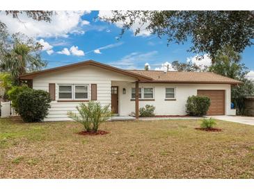 Charming single-story home featuring a well-manicured front yard and a classic brick and siding exterior at 121 Shirley Dr, Largo, FL 33770