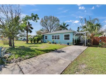 Charming single-story home featuring a well-manicured front yard and a welcoming pergola-covered entrance at 2661 45Th S St, Gulfport, FL 33711