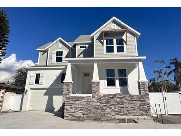 Beautiful two-story home featuring stone accents, white trim, and a welcoming front porch at 3404 S Omar Ave, Tampa, FL 33629