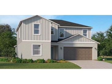 Beautiful two-story home with vertical siding, concrete foundation, and a two car garage at 10248 Purple Leaf Ct, Riverview, FL 33578