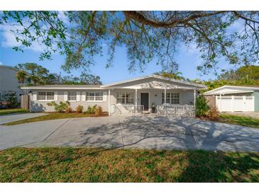 Charming single-story home featuring a lovely front porch and well-maintained landscaping at 1489 77Th N Ave, St Petersburg, FL 33702