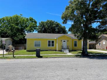 Charming yellow house with a spacious yard and detached garage at 2734 53Rd N Ave, St Petersburg, FL 33714