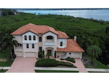 Stunning waterfront home boasts a grand exterior and beautiful landscaping at 109 Wateredge Ct, Safety Harbor, FL 34695