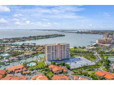 Aerial view of a waterfront high-rise building with parking and a pool at 4900 Brittany S Dr # 1303, St Petersburg, FL 33715