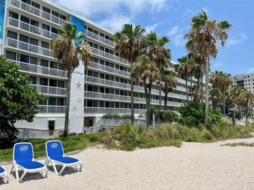 Hotel building exterior with beach access and tropical landscaping at 5500 Gulf Blvd # 7211, St Pete Beach, FL 33706