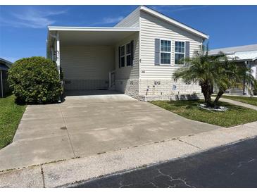 Single-wide manufactured home with carport and landscaped yard at 13225 101St St # 482, Largo, FL 33773