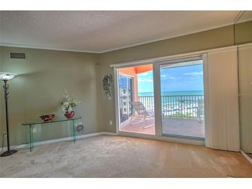 Spacious living room with ocean view, fireplace and balcony access at 18400 E Gulf Blvd # Ph-11, Indian Shores, FL 33785