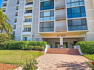 Exterior of Yacht House building, 851 Bayway, featuring landscaping and entrance at 851 Bayway Blvd # 205, Clearwater Beach, FL 33767