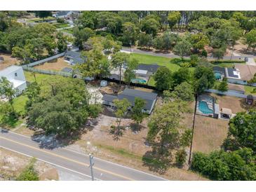 Aerial view of a single-story home with a large backyard and pool at 7414 Van Dyke Rd, Odessa, FL 33556