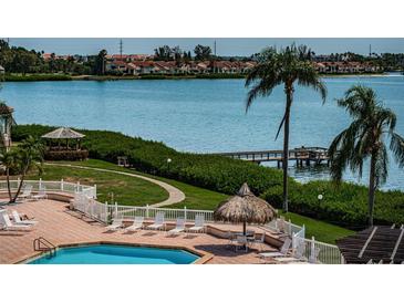 Relaxing pool area with waterfront views and lounge chairs at 6268 Palma Del Mar S Blvd # 406, St Petersburg, FL 33715