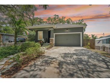 Gray craftsman style home with a two-car garage and landscaped front yard at 131 Pennsylvania Ave, Palm Harbor, FL 34683