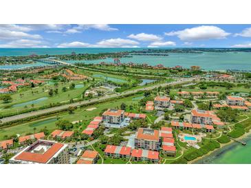 Expansive aerial view of a waterfront community, golf course, and Sarasota Bay with blue skies at 6269 Palma Del Mar S Blvd # 608, St Petersburg, FL 33715