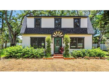 Charming two-story home with a manicured front yard and inviting green entryway at 5518 21St S Ave, Gulfport, FL 33707