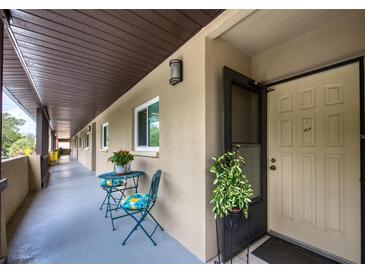 Inviting condo hallway featuring table and chairs with potted flowers, leading to unit #304 at 1245 S Martin Luther King Jr Ave # 304, Clearwater, FL 33756