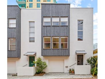 Modern townhouse exterior with gray siding and white accents at 106 Fareham N Pl, St Petersburg, FL 33701