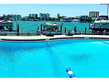 Inviting community pool with waterline and waterfront views at 660 Island Way # 401, Clearwater, FL 33767