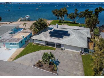 Stunning waterfront home featuring a new roof with solar panels and a private dock on a picturesque bay at 4751 Baywood Point S Dr, Gulfport, FL 33711