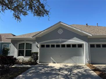 Gray house with two-car garage and landscaped front yard at 6926 Surrey Oak Dr, Apollo Beach, FL 33572