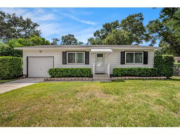 Charming single-story home with well-manicured lawn and trimmed hedges at 707 2Nd Se St, Largo, FL 33771