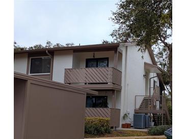 Two-story condo building with private balconies and exterior stairs at 635 Fairmont Ave # D, Safety Harbor, FL 34695